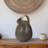 Decorative Terracotta Vase with Sculpted Form, Tilted Mouth, Matte Pottery Texture, and Woven Rattan Wrapped Handle for Textural Contrast and Handcrafted Visual Interest in Casual Home Accents-1884392258