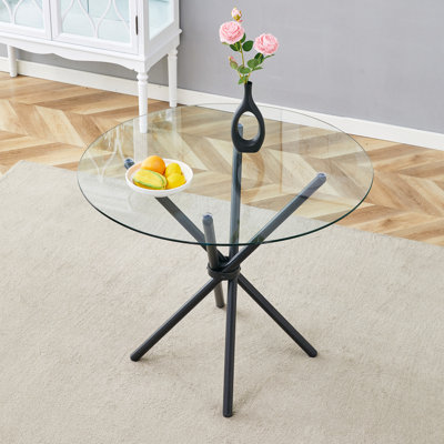 Table ronde circulaire en verre trempé transparent de 36,6 po de diamètre, avec pieds en métal noir rassemblés en forme d'anneau. Le verre du bureau mesure 0,3 po d'épaisseur.