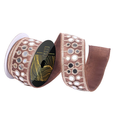 2.5" x 5yd Chocolate Metallic Wired Ribbon with Mirror Circles. Chocolate Metallic Backing. Measuring 2.5 inches in width and 5 yards in length, it's perfect for a variety of festive projects.