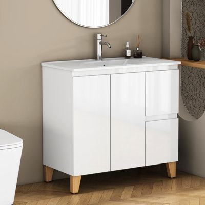 Meuble-lavabo moderne de 91 cm (36 pouces) avec lavabo intégré, 2 portes et tiroirs à fermeture amortie, poignées élégantes, pieds en bois naturel, lavabo en céramique blanche facile à installer, tiroirs et placards de rangement.
