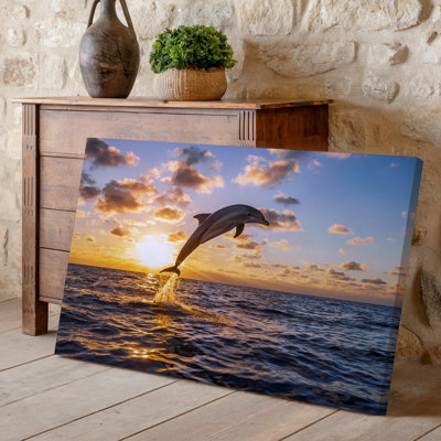 Canvas A Majestic Dolphin Leaps Gracefully Out Of The Shimmering Ocean Wall Art Captured Mid Air Against A Stunning Sunset Backdrop Canvas Wall Art