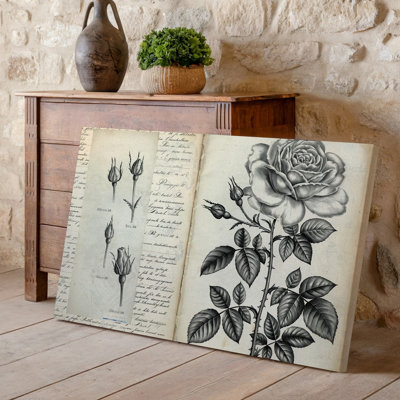 Toile d'une délicate illustration monochromatique d'une rose en fleurs et de ses bourgeons avec des détails complexes sur les pétales et une toile