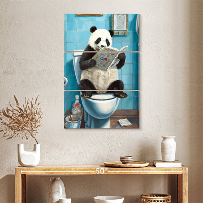 Ketti panda sur une toilette