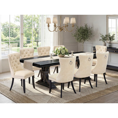 9-piece dining table set consists of a dinner table and 8 Light Beige Polyester Fabric dining chairs with Button Tufted Chair Back - Sand Blasting Black Finish.