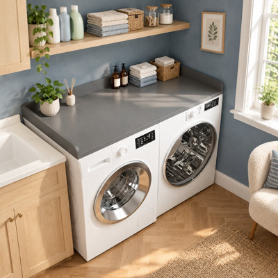 A gray wooden countertop with an edge spans washers and dryers for laundry-room organization, measuring 27.5 x 54 inches.