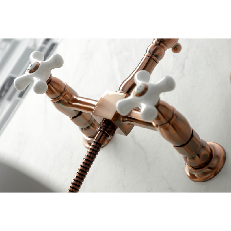 Kingston Brass Heritage Double-Handle 3-Hole Wall-Mount Bridge Kitchen Faucet with Brass Sprayer, Antique Copper
