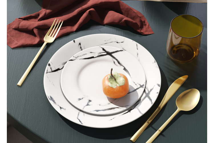 marble dishware and gold flatware
