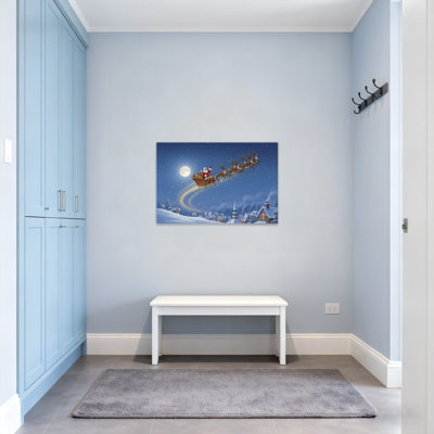 Noël père Noël survolant la ville enneigée
