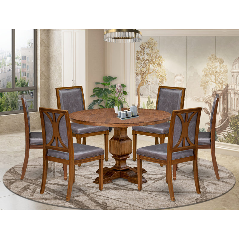 L'ensemble de table 7 pièces comprend une table ronde en bois et 6 chaises en similicuir gris foncé à haut dossier, finition noyer antique.