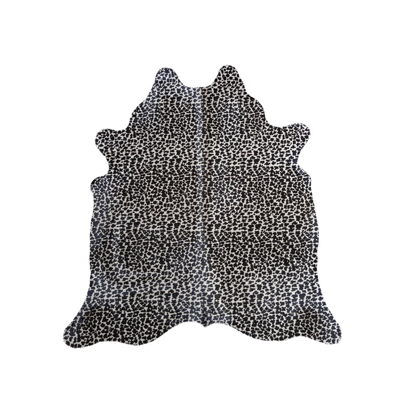 Tapis noir / blanc en peau de vache à imprimé animal