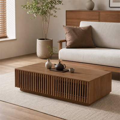 Mid-century style solid wood rectangular low coffee table featuring slatted drawers for concealed storage—a farmhouse-style living room storage coffee