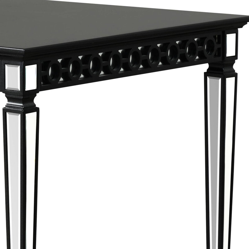 Élégante table de salle à manger noire avec tablier géométrique et plateau rectangulaire en bois avec décoration en miroir