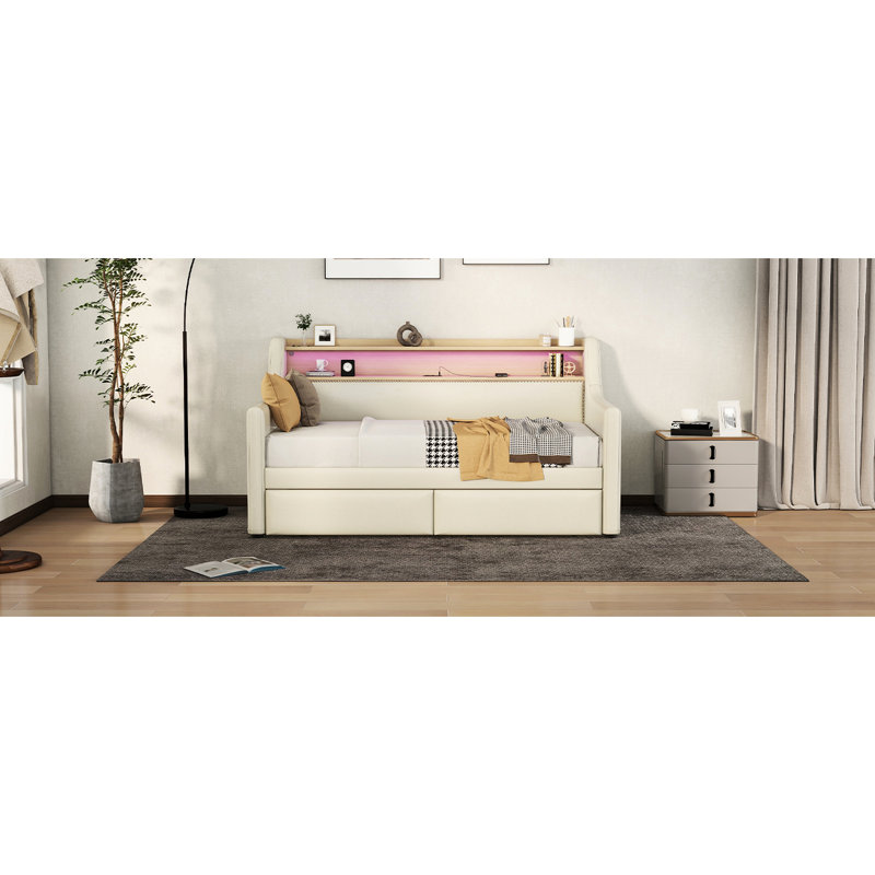 Lit de jour simple rembourré beige avec rangement pour magazines, prises de courant et options de rangement d'ambiance à DEL colorées, lumières personnalisables pour ports de charge