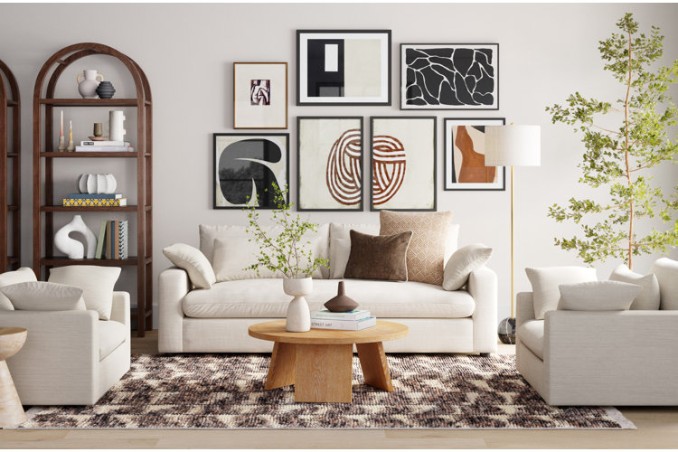 japandi living room with white furnishings,a wood coffee table, brown area rug, abstract artwork, and a large faux tree.