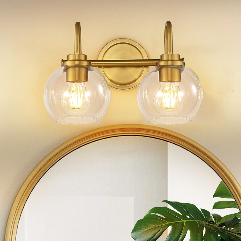 Applique murale pour salle de bain 2 lumières dorées au-dessus d'un miroir avec abat-jour en verre transparent