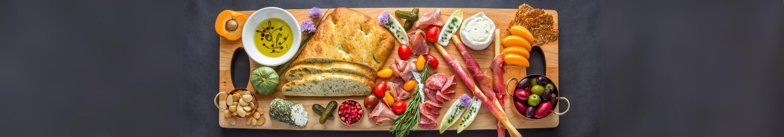 JK Adams Grafton Cherry Server lifestyle of charcuterie board with bread, cheese and veggies.