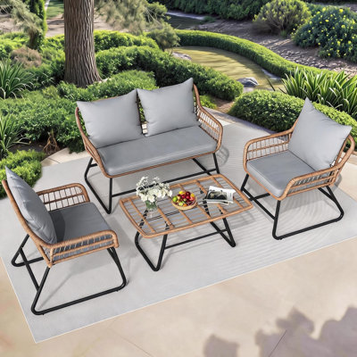 Ensemble 4 pièces de canapé de patio moderne en osier gris avec pieds droits, coussins amovibles, table en verre trempé, résistant aux intempéries, parfait pour le balcon, le porche et l'ensemble de quatre coussins à bord droit près de la piscine