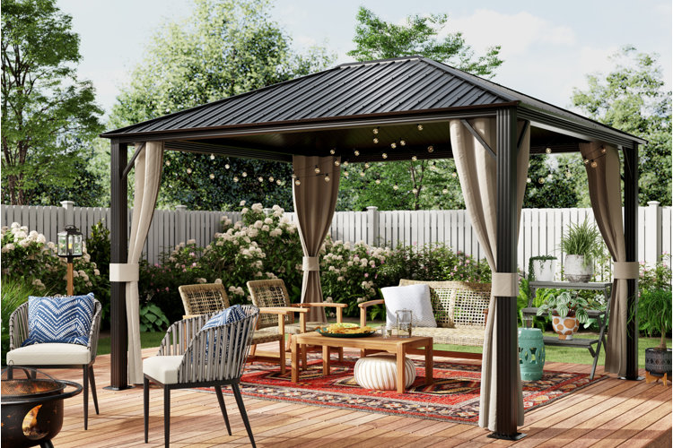 hard-top gazebo with a rattan seating set, red outdoor rug, and globe-shaped outdoor string lights