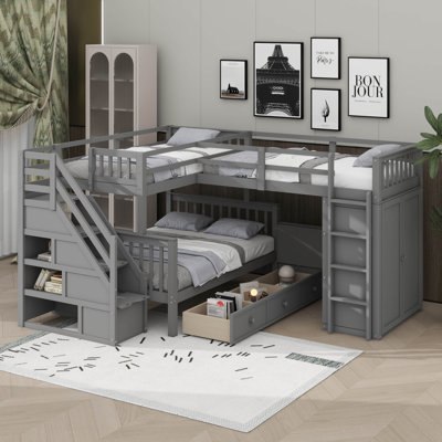 Lit simple superposé au dessus d'un lit double avec tiroirs, bureau et garde-robe