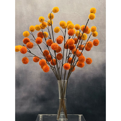 Arrangement artificiel de boules de billy orange et rouges dans un vase
