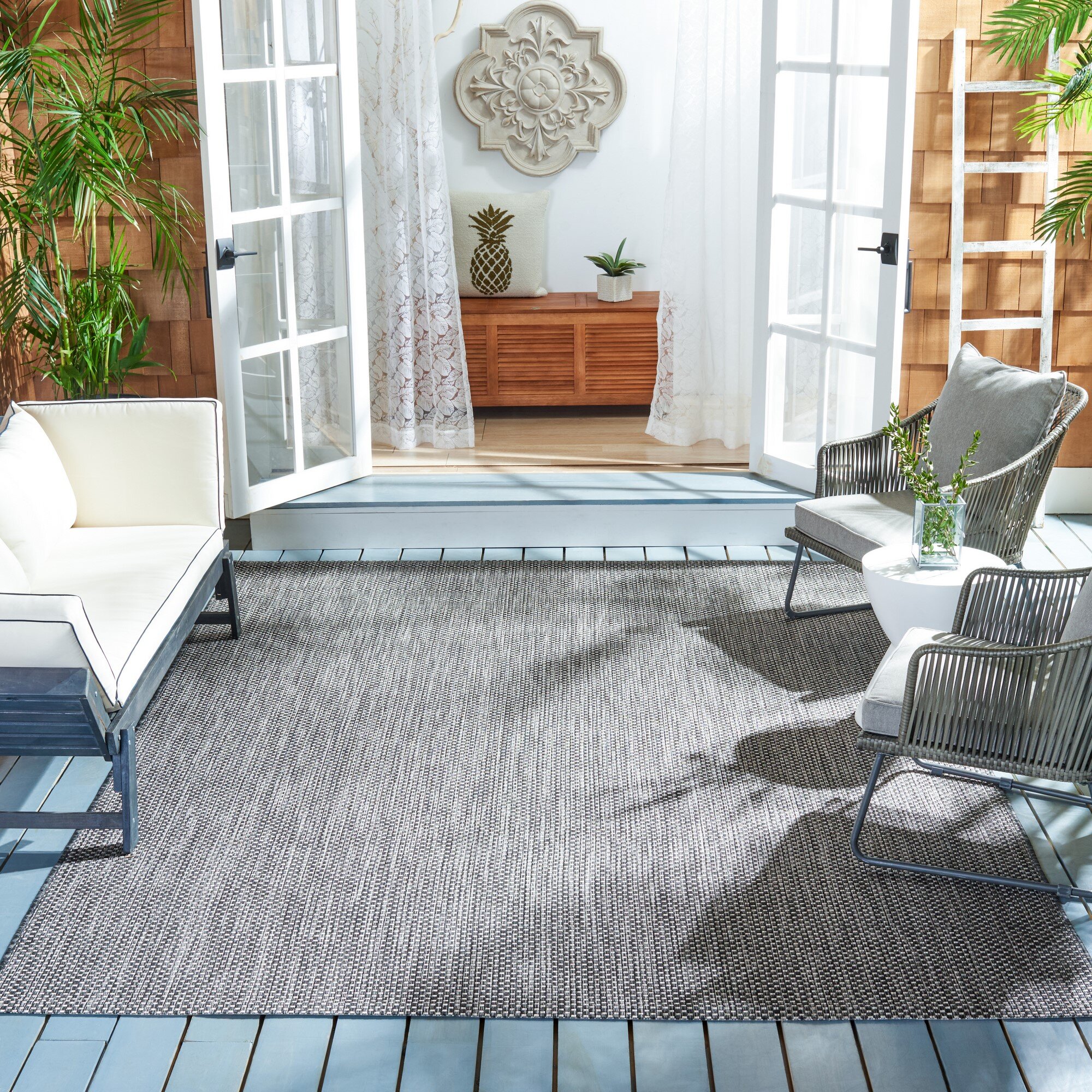 https://assets.wfcdn.com/im/44378962/compr-r85/1430/143089355/sezis-polypropylene-blend-blackbeige-indooroutdoor-rug.jpg