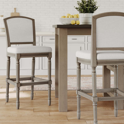 Tabouret de bar gris patiné avec assise et dossier rembourrés gris