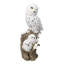 Figurine familiale représentant une chouette harfang des neiges et ses deux petits sur une souche d'arbre enneigée