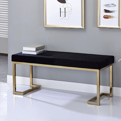 Banc élégant avec siège rembourré noir et base en métal champagne pour chambre à coucher avec pieds