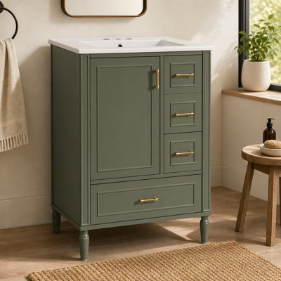 Meuble-lavabo moderne de 61 cm (24 po) avec lavabo en céramique, porte à fermeture amortie, trois tiroirs, poignées dorées et tablette de rangement.