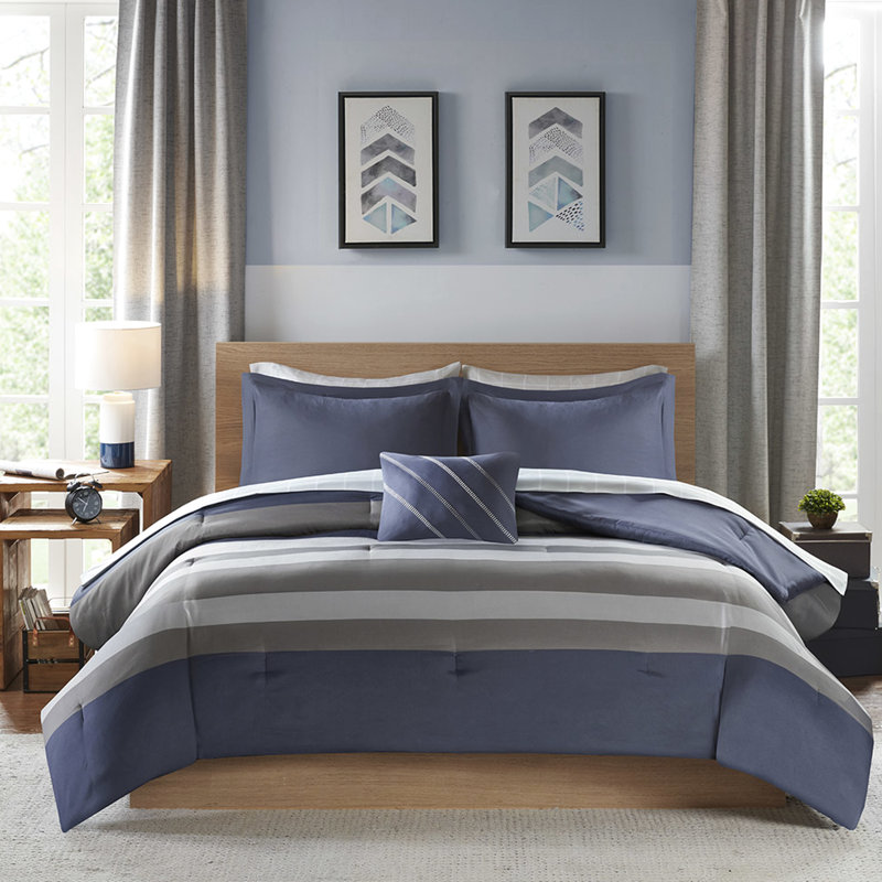 Twin Bedroom With Blue Grey Striped Sheets And Comforter & Round Pillow