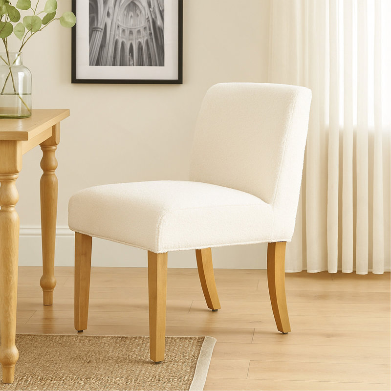 Chaise de salle à manger Kip avec pieds en bois de chêne miel, tissu bouclé