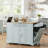 A Practical Gray-Blue Kitchen Island With Five Wheels For Easy Movement, Complete With Drawers And Side Shelves, And Includes A Trash Can Cabinet And Power Outlet.-2118873774