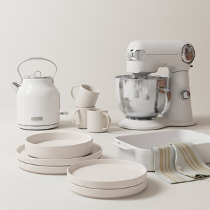 White Haden kettle, stand mixer, mugs, and dishes on a white surface.