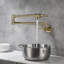 Robinet remplisseur mural avec poignées doubles et bras pivotant