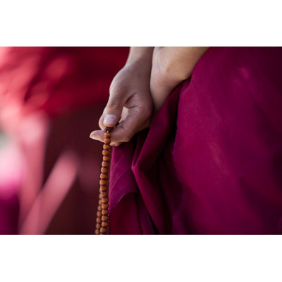 A Monk In Traditional Clothing Holding Prayer Beads by Hanhanpeggy - Wrapped Canvas Print