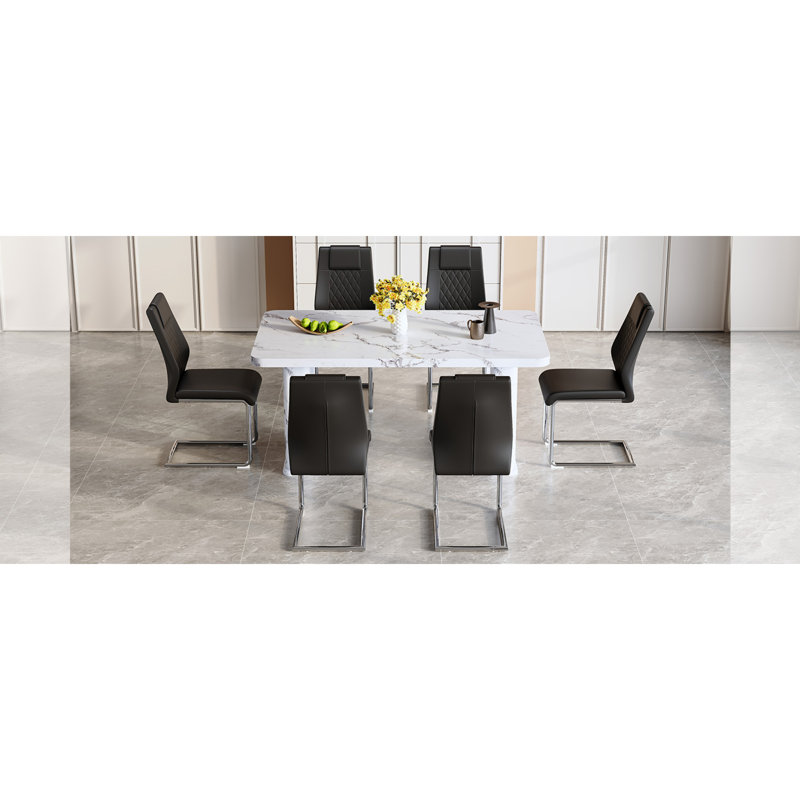 Ensemble de table de salle à manger élégant en marbre blanc avec 6 chaises en polyuréthane noir, pieds en métal arqués argentés - Design moderne et élégant pour les salles à manger et les cuisines