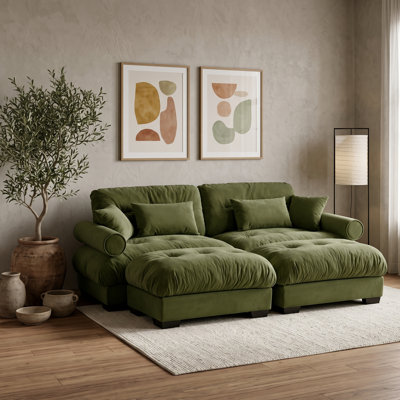 Canapé modulable 2 places en velours vert, avec 2 poufs amovibles, coussins de dossier et traversins.