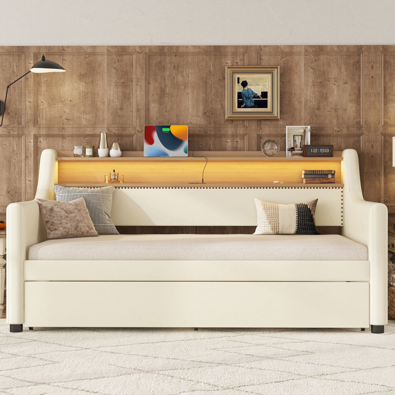 Lit de jour simple rembourré blanc avec lit gigogne, ports de charge, lumières à DEL et prise de rangement pratique, et possibilité de couchage supplémentaire