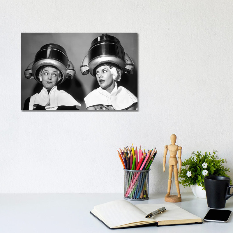 1950s Two Women Sitting Together Gossiping Under Hairdresser Hair Dryer by Vintage Images - Wrapped Canvas Print