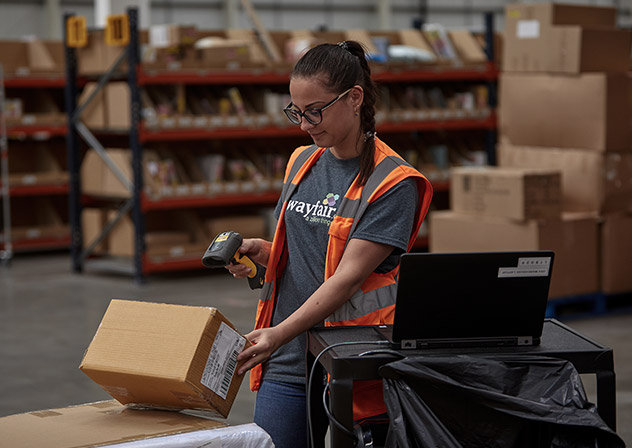 A worker scanning a package in a warehouse