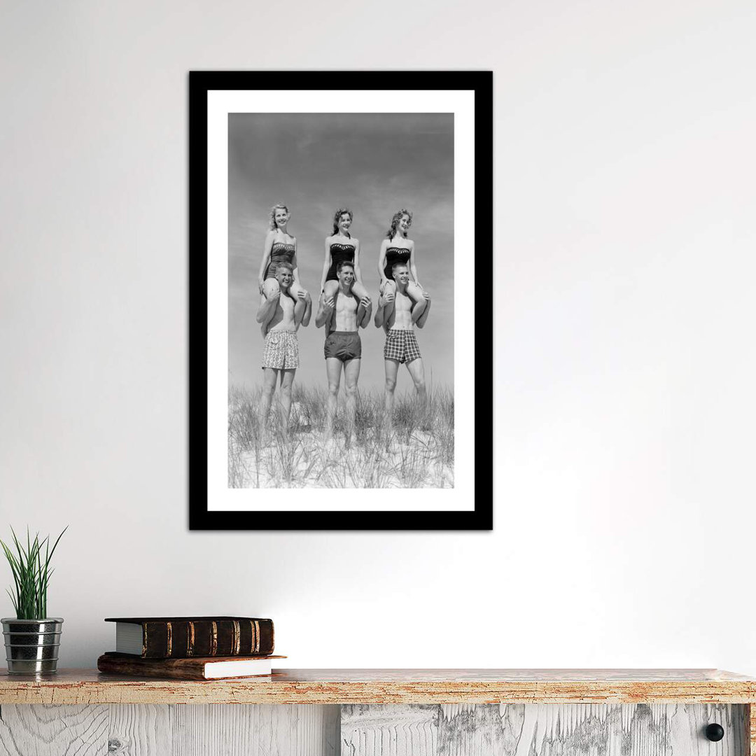 " 1950s-1960s Three Couples At Beach On Dunes With Women In Identical Bathing Suits Sitting On Men's Shoulders " by Vintage Images East Urban Home 