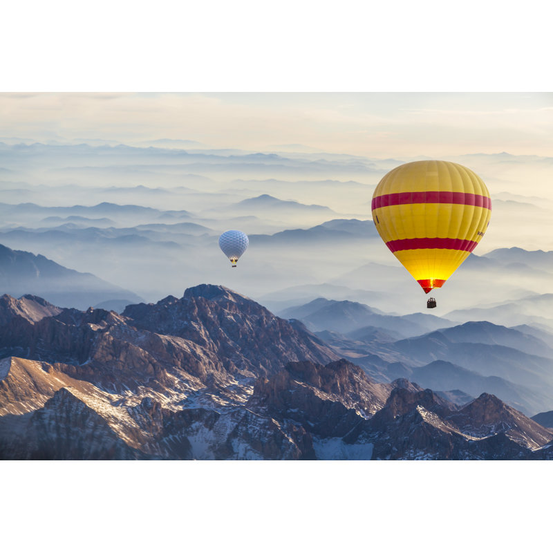 Hot Air Balloon Flying Over Fogy Mountains by Guvendemir - No Frame Print on Canvas, 61cm H x 91cm W