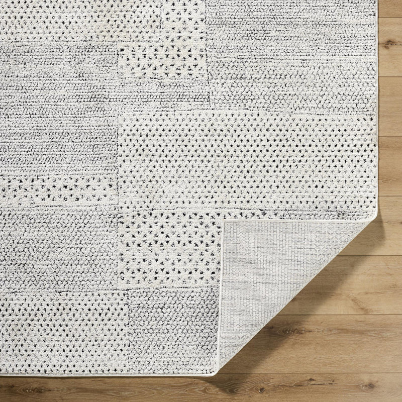 Ivory and Black Geometric Patchwork Area Rug, 6'7" x 9'