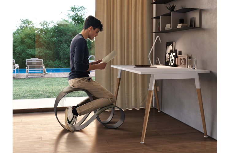 Man in home office using kneeling desk chair