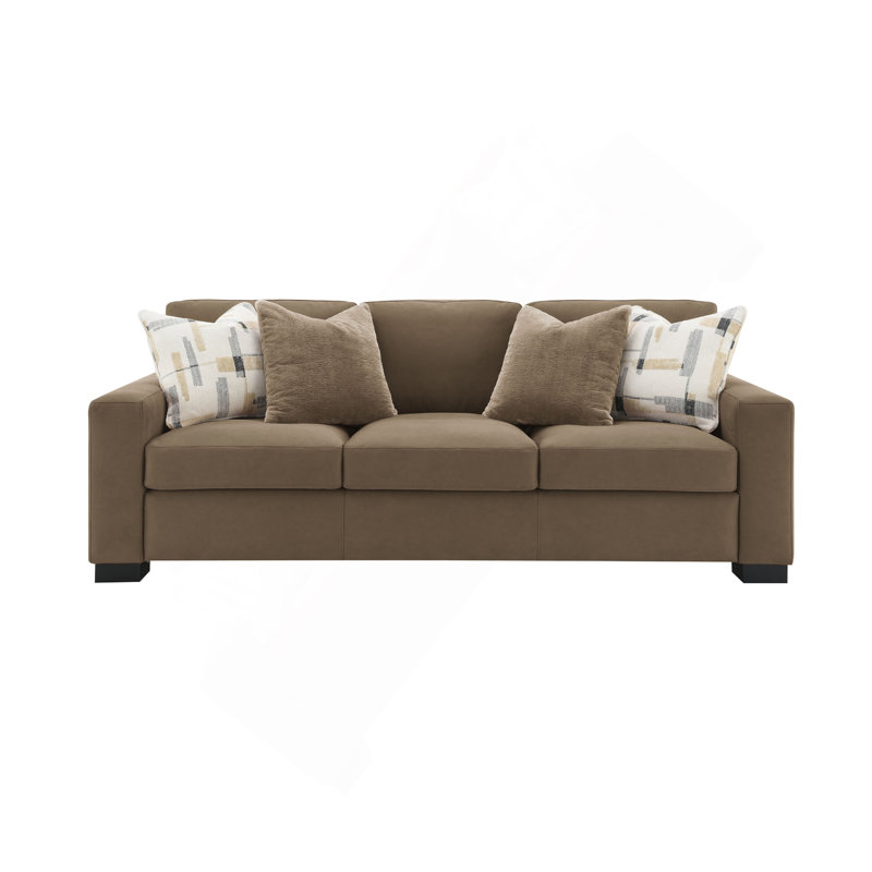 Canapé confortable en suède avec plusieurs coussins et fabrication robuste