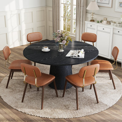 Ensemble de table et chaises de salle à manger rondes modernes de 119 cm (47 po) pour 4 à 6 personnes, avec pied central et chaises rembourrées.