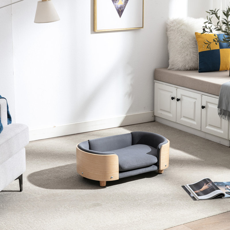 Animal de compagnie surélevé avec un design scandinave contemporain, des pieds en chêne massif, de la mousse rebondie gris foncé, imperméable et résistant aux taches, un lit pour chien de petite taille à installation rapide