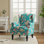 Fauteuil à oreilles tapissier à motif floral bleu paon avec garniture cloutée Duward