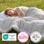 Light gray box-stitch comforter on a person sleeping outdoors