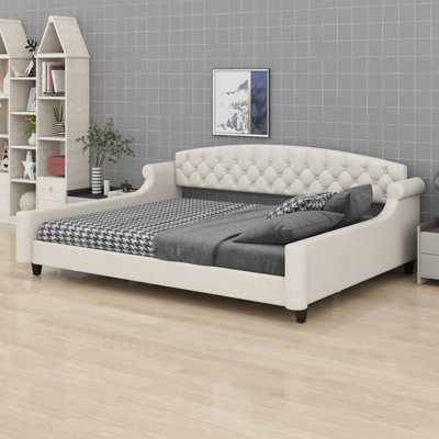 Daybed with thick slat panels and deep button tufting for living rooms or guest spaces